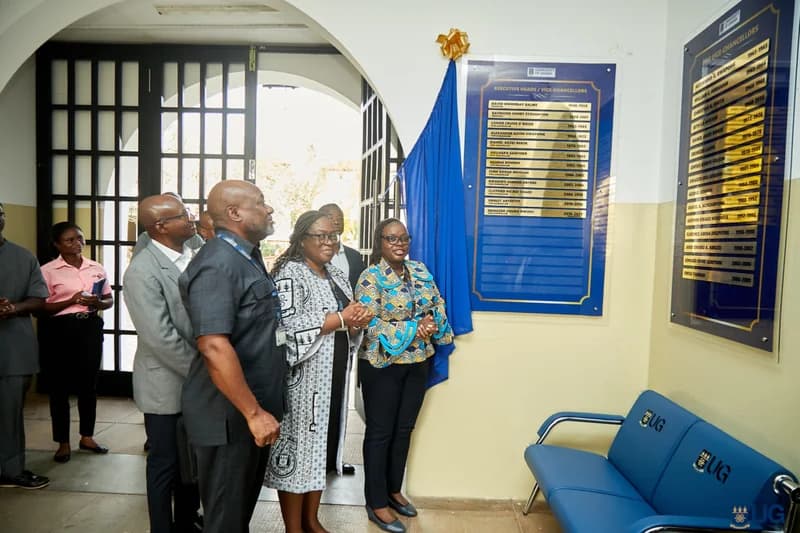 Officials and dignitaries from the University of Ghana stand before two newly unveiled 'Walls of Honour' plaques at the institution's registry. The ceremony features prominent leaders, including Professor Nana Aba Appiah Amfo, standing near the blue display boards listing past Vice-Chancellors and Pro Vice-Chancellors.