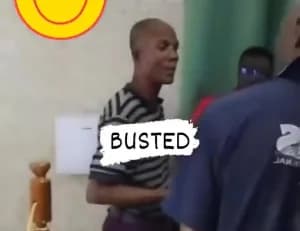 A man in a horizontal-striped shirt appears to be confronted or apprehended by others in an indoor setting. A prominent graphic with the text 'BUSTED' is superimposed over the center of the frame, signifying the capture of a suspect.