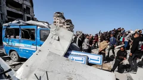 Reuters A police mini van with rubble on top of it, surrounded by several people