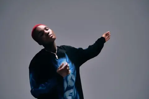 Sullman Arlo Parks closes her eyes and dances to a piece of music, in a promotional shot for her new album, Ambiguous Desire