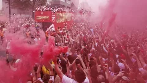 EPA Arsenal players celebrate with the Premier League trophy on an open-top bus during Arsenal Champions Parade in north London on Sunday.