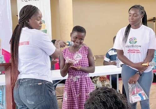 A pupil demonstrating how to wear a sanitary pad
