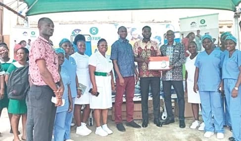 Mohammed-Anwar Sadat Adam (4th from right), Country Director of Oxfam Ghana, presenting medical equipment to Dr Amos Kofi Pepprah (5th from right), the acting Medical Superintendent of Ewim Polyclinic. With them are some health workers of the polyclinic