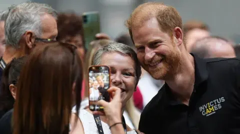 PA Media Prince Harry having a selfie taken with supporters of the Invictus Games in Birmingham