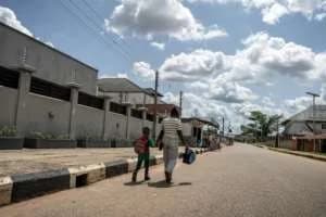 A woman who was trafficked to Europe walks hand in hand with her son in Benin City. By Light Oriye Tamunotonye (AFP)