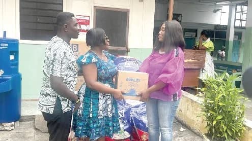 Sheela Sakyi Oppong (right) presenting the items to Dr Margaret Neizer (middle)
