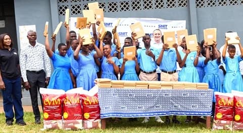 SMT Ghana team, including Amaury Lescaux (middle) and Hilda Peasah (left), with the students displaying the braille sheets