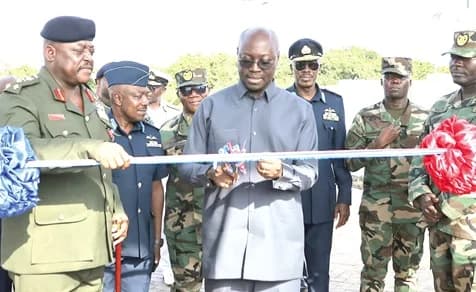 Dr Cassiel Ato Forson (middle), acting Minister of Defence, cutting the tape to inaugurate the Butler Barracks complex (inset), with support from Lt Gen. William Agyapong (left), Chief of the Defence Staff