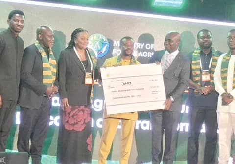 Bennet Nyasembi (middle), Financial Controller, Farmerline Consult Ltd, presenting the dummy cheque for GH¢3.5 million to Eric Opoku, Minister of Food and Agriculture