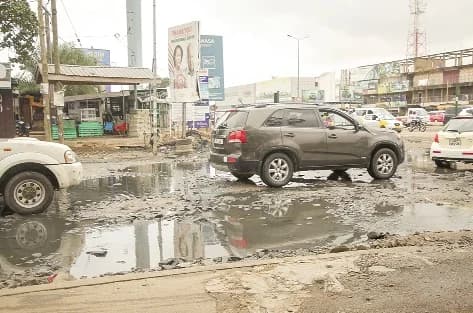 A section of the Hansonic road in Accra left severely degraded with deep potholes, muddy surfaces and stagnant water making movement difficult for motorists and commuters (below). Picture: CALEB VANDERPUYE