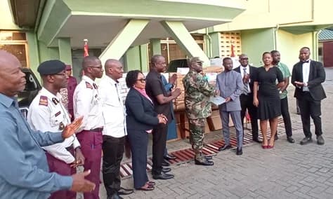 Daniel Afari Danquah (3rd from right), Co-founder and CEO of Mood Data Services Limited, presenting the items to Major General Maxwell Obuba Mantey (6th from right), Director-General of NACOC. With them are some staff of NACOC and Mood Data Services Limited