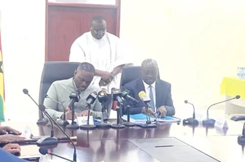 Dr Cassiel Ato Forson (right), and Kenneth Gilbert Adjei, newly appointed Defence Minister, signing documents to formalise the handover of the Ministry of Defence. With them is Ernest Brogya Genfi, the Deputy Minister of Defence
