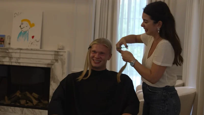 Erling Haaland sat down having a haircut