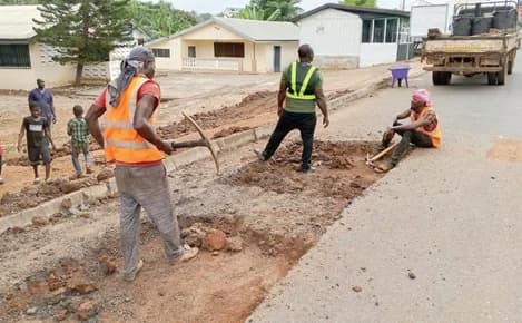 A group of workers patching potholes near the Ho Mawuli Estates