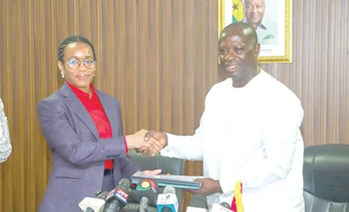 Emmanuel Armah-Kofi Buah (right), Minister of Lands and Natural Resources, handing over documents to Dr Zanetor Agyeman-Rawlings, Minister of Environment, Science and Technology