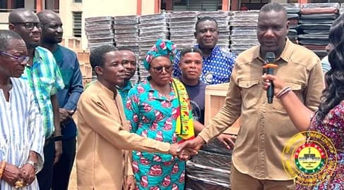 Maxwell Kwame Lukutor (right), Member of Parliament for South Tongu, in a handshake with a representative of one of the zones visited