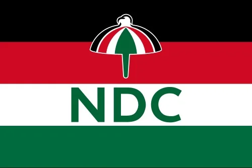 The official flag of the National Democratic Congress (NDC), one of Ghana's major political parties. The flag features horizontal stripes of black, red, white, and green, with the party's umbrella symbol and the text 'NDC' centered on the white stripe.