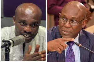 A composite image showing a split-screen of two prominent Ghanaian figures engaged in discussion. On the left, a man in a white garment speaks into a studio microphone, while on the right, a man in a suit and glasses points emphatically while speaking into a desk microphone.