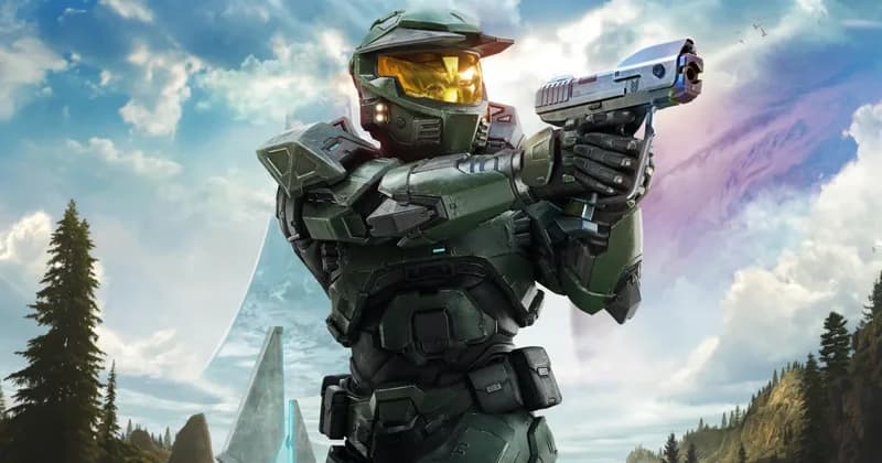 The image shows Master Chief, the iconic protagonist of the Halo video game series, in his signature green Spartan armor while aiming a pistol. The background features a picturesque landscape with mountains, pine trees, and a massive artificial ring structure under a bright, cloudy sky.