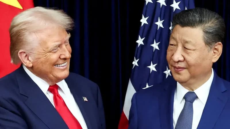 This photograph captures Donald Trump and Xi Jinping during a diplomatic meeting, both leaders appearing to share a lighthearted moment. Behind them are the national flags of the United States and China, emphasizing the high-stakes nature of the bilateral summit. The image represents the intersection of global politics and the ongoing competition between the two superpowers.