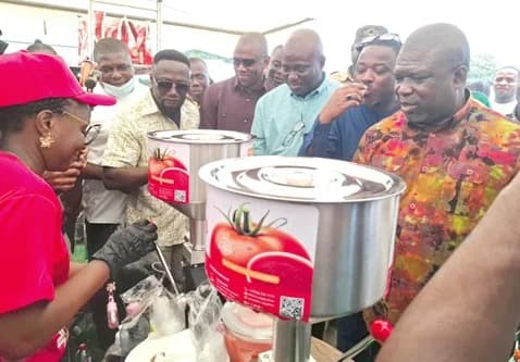 Eric Opoku (3rd from right), the Minister of Food and Agriculture, and James Gunu (right), Volta Regional Minister, and others inspecting packaged fresh tomatoes at the exhibition stands at the launch of the Ghana Tomatoes Self-Sufficiency Initiative at Anloga in the Volta Region