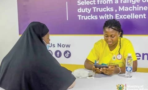 One of the returnees (left) being taken through the arrival formalities at the airport