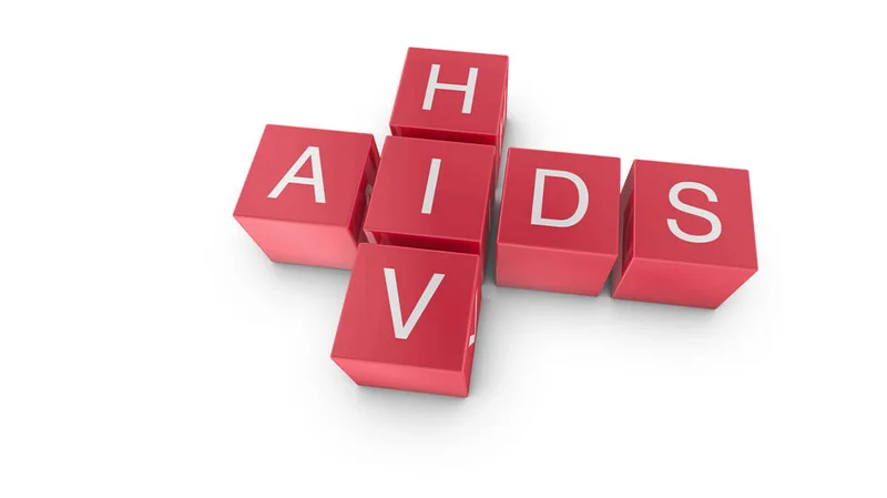 A 3D graphic illustration featuring red cubes arranged in a cross shape against a white background. The vertical cubes spell 'HIV' while the horizontal cubes spell 'AIDS', sharing the central letter 'I'.