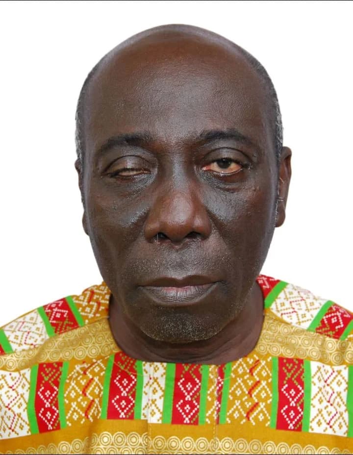 A headshot of Yaw Ofori-Debra, a prominent Ghanaian advocate for persons with disabilities and political figure. He is wearing a vibrant yellow, green, and red patterned shirt against a plain white background.