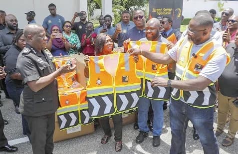 Samson Oddoye (right), National Coordinator, Street Sense Organisation, presenting a reflective vest to Christian Tetteh Yohuno (left), Inspector-General of Police. Picture: ELVIS NII NOI DOWUONA