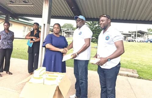 Prof. Victor Wutor (middle), Founder and Executive Director of Asthma Ghana, presenting the devices to Sena Kove, Head of Domestic SUB-BMC of the Ho Teaching Hospital