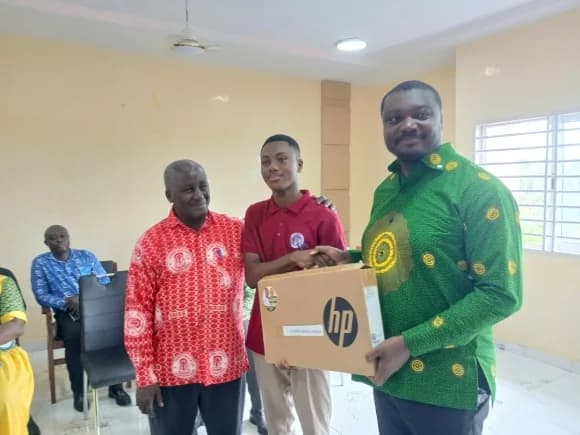 Nana Ampaw Kwame Addo-Frempong (right), MP for Abuakwa North presenting one of the laptops to Richard Kwabena Damoah of Bright SHS at Kukurantumi. Looking on is the Headmaster of the school, Dominic Acquah.