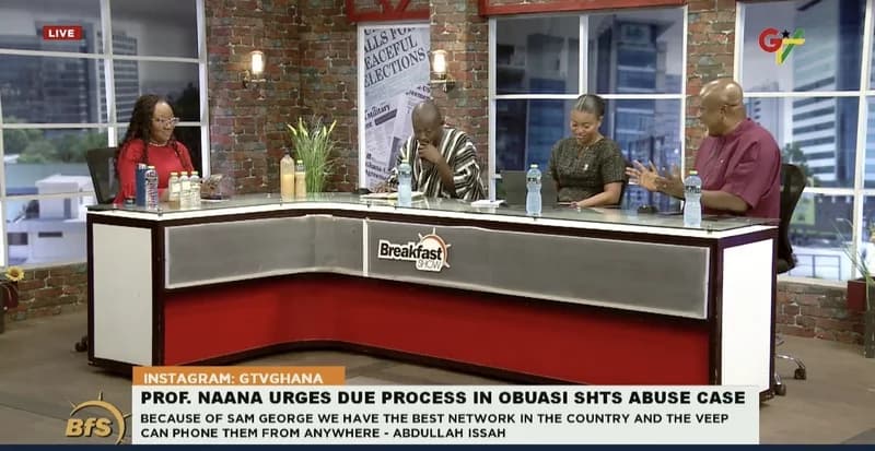 A panel of four commentators discusses current affairs on the GTV 'Breakfast Show' set. The studio features a modern desk with 'Breakfast Show' branding against a backdrop of brick walls and city-view windows. A news ticker at the bottom highlights a discussion regarding the Obuasi SHTS abuse case.